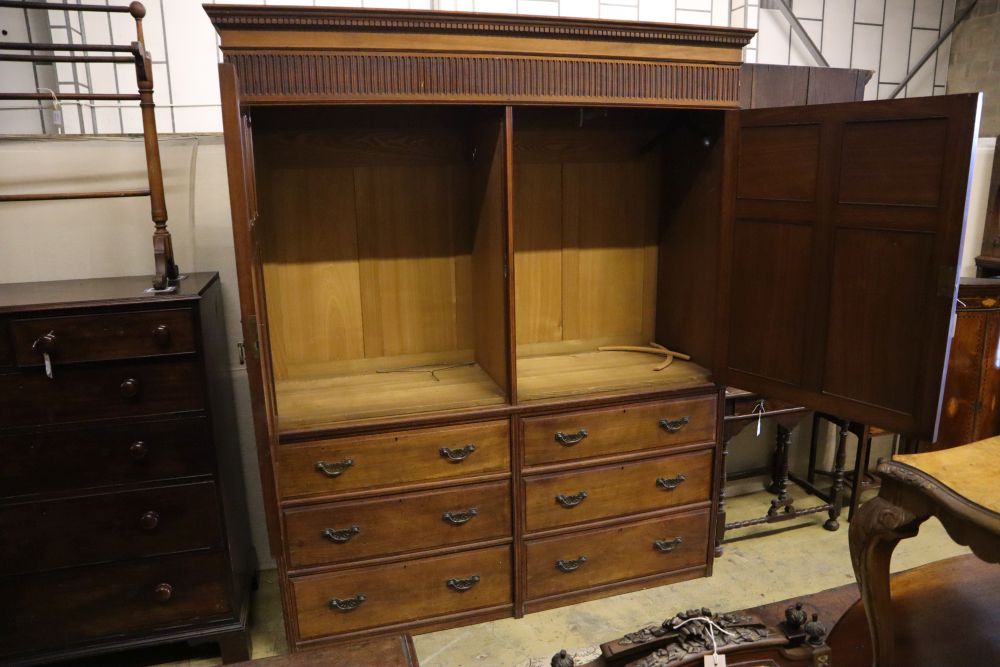 A large late Victorian walnut wardrobe, with fielded panelled doors over six small drawers, width 180cm depth 60cm height 210cm